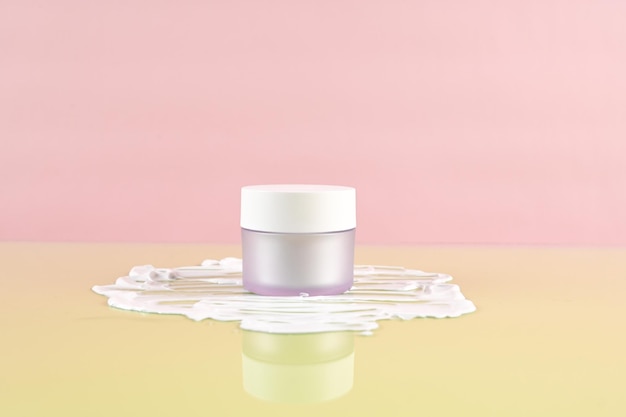 Moisturizer facial or eye cream in white frosted glass jar Empty cosmetic jar on the background of the cream texture Pastel background with copy space High quality photo