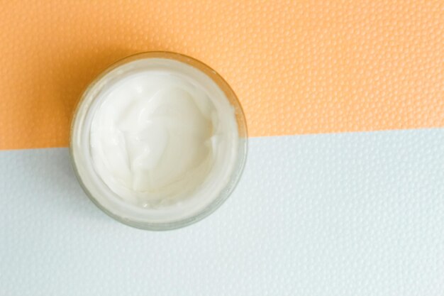 Moisturizing spf cream in a jar on a light background