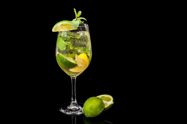 Mojito on a black background, lime, lemon mint