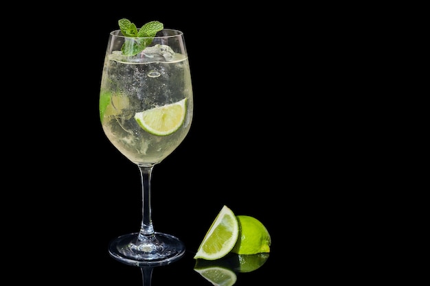 Mojito on a black background, lime, lemon mint