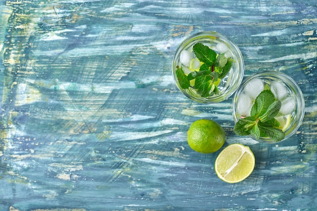 Mojito cocktail on the grey concrete background.