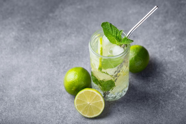 Mojito cocktail with lime and mint in a highball