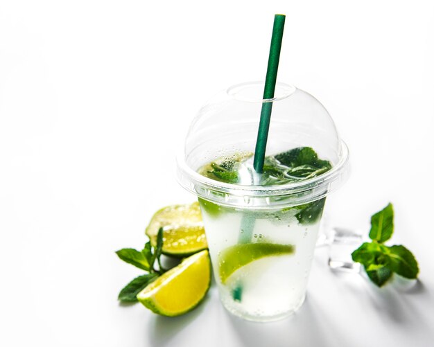 Mojito cocktail with lime and mint on white background