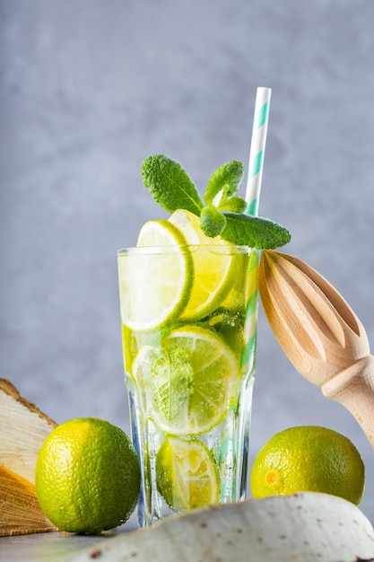 Mojito in glass with lime, fresh mint and ice