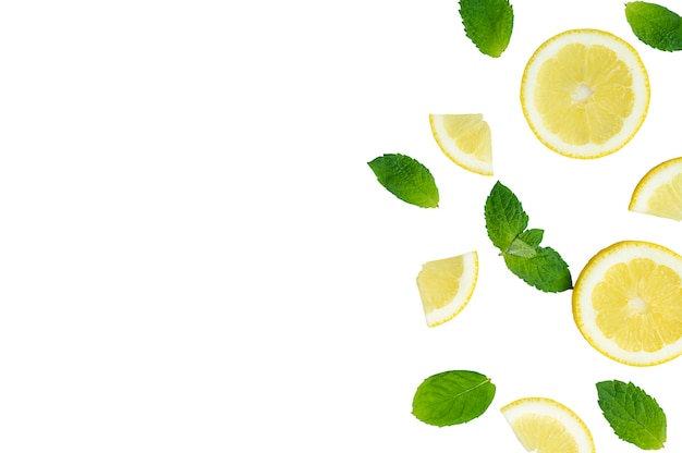 Mojito lemonade cocktail or sour infused water ingredient flatlay with sliced lemon and mint leaves