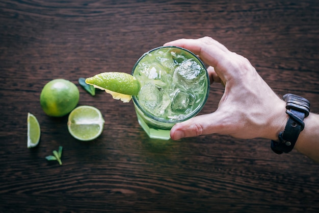 Mojito with lime on wooden table