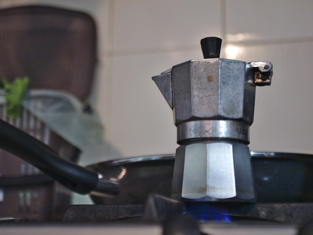 A moka pot for coffee on the stove