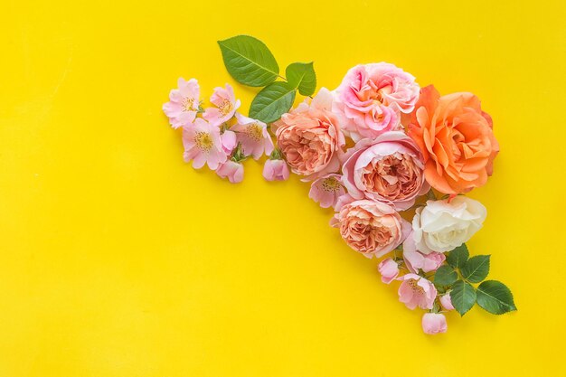 mokap on a yellow background with roses and copy space