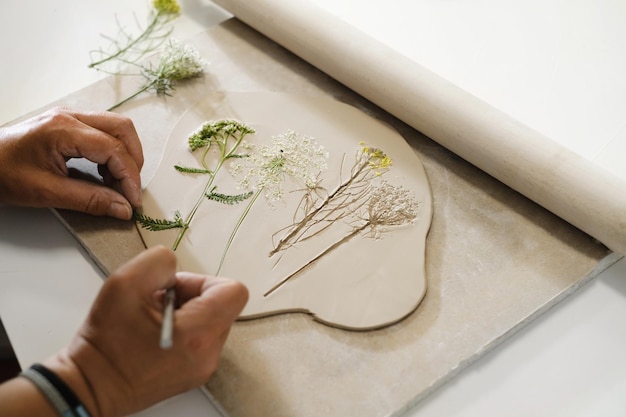 Molding clay bowl on pottery workshop with floral print