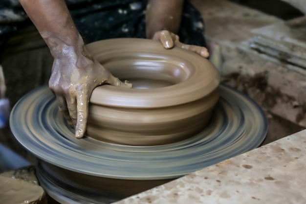 Molding on a rotary platform by hands.