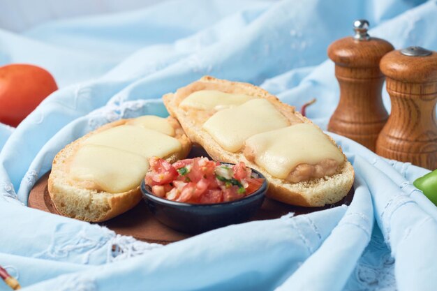 Molletes typical Mexican food in wooden plate