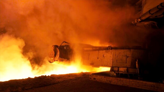 Molten steel pouring process with steam clubs at metallurgical plant stock footage close up fot