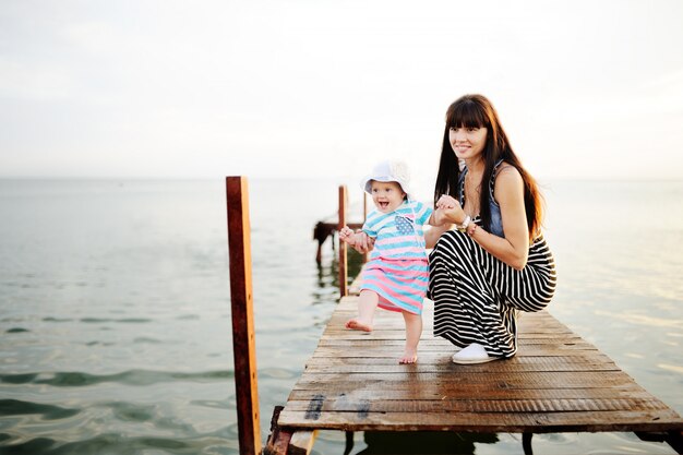 Mom and baby daughter at sunset   