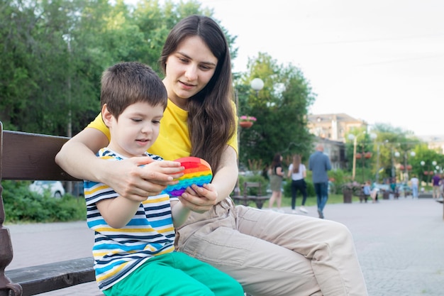 Mom and boy play pop it.