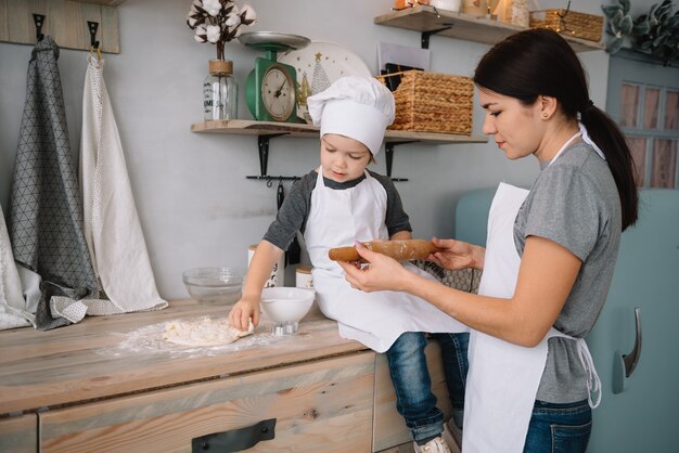 mom and boy preparing dough for Christmas cookies