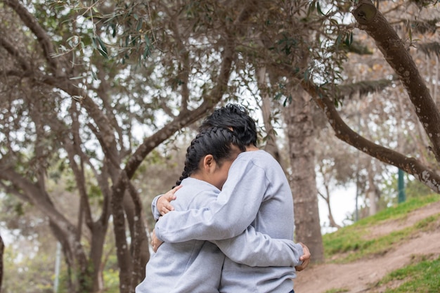 Mom and child Family members hugging on an outdoor location park