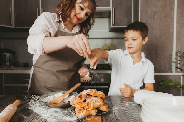 Mom and child prepare a birthday cake in the kitchen for Mother's Day, a series of pictures of everyday lifestyle in the interior from real life