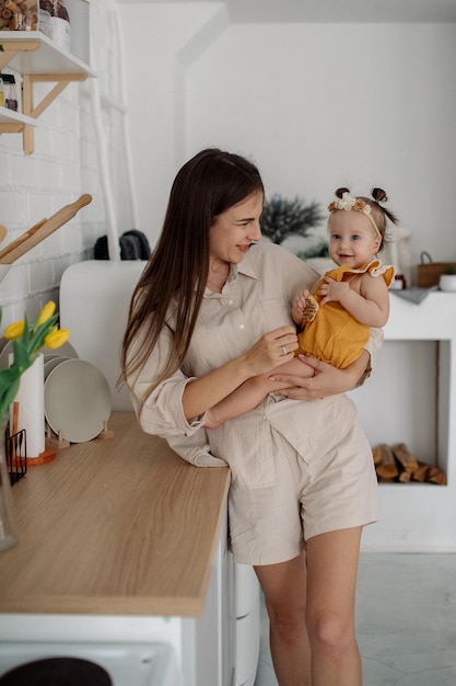 Mom and daughter are hugging in the kitchen Family life at home