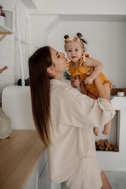 Mom and daughter are hugging in the kitchen Family life at home