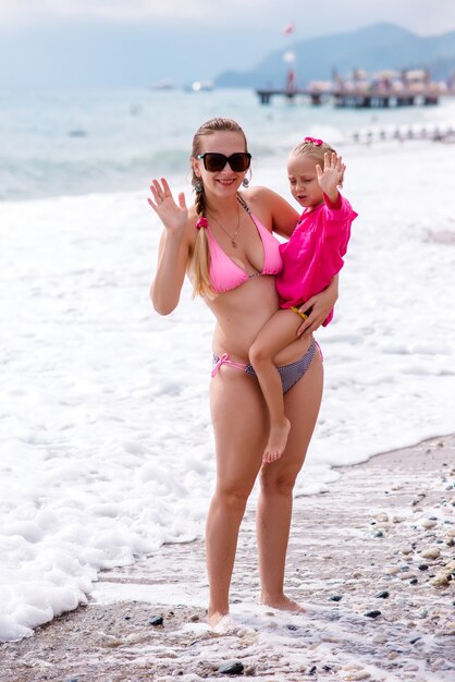 Mom and daughter are resting on the beach