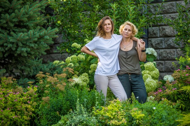 Mom and daughter in a beautiful garden