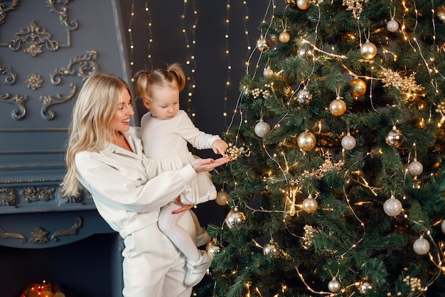 Mom and daughter decorating Christmas tree together