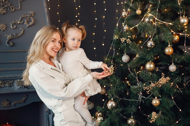 Mom and daughter decorating Christmas tree together