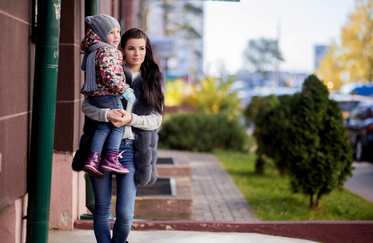 Mom and daughter on the doorstep of the house