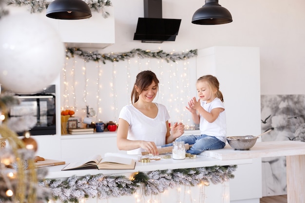 Mom and daughter have fun in the kitchen on Christmas Day