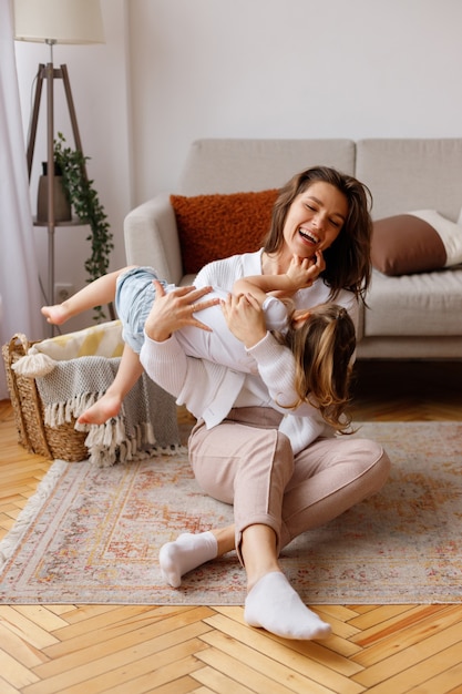 Mom and daughter having fun at home on holiday