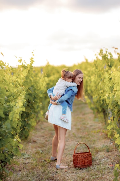 mom and daughter having fun in the vineyard