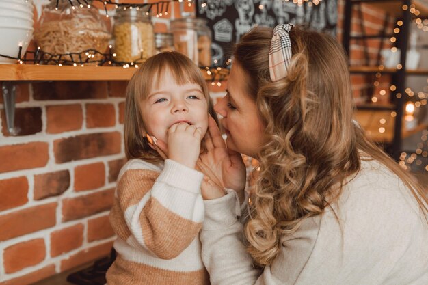 Mom and daughter in the kitchen with a herringbone-shaped plate. biscuits on a plate.