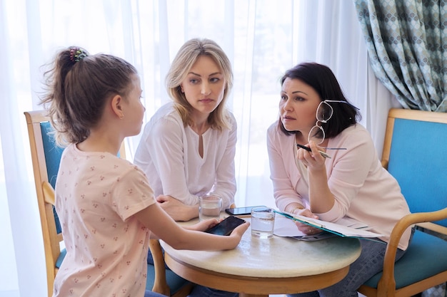 Mom and daughter preteen child at meeting with psychologist therapist