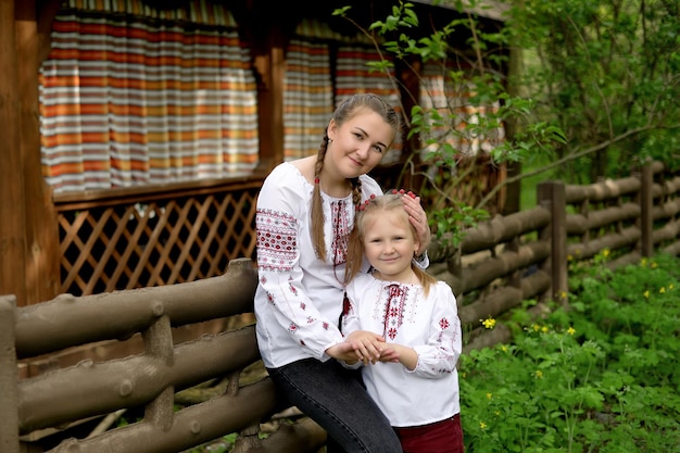 Mom and daughter smiling in Ukrainian embroidered shirts Ukrainian tradition