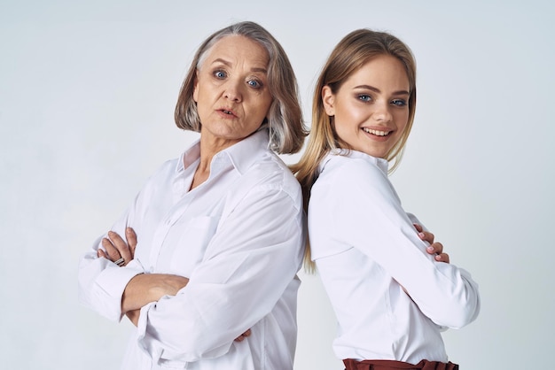 Mom and daughter in white shirts stand side by side emotion family love