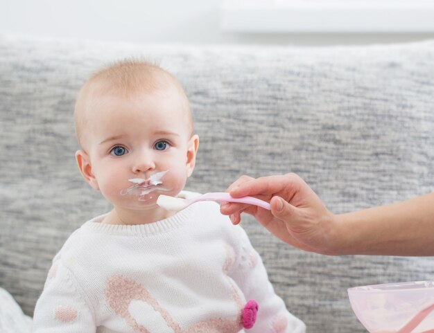 Mom feeding baby indoor