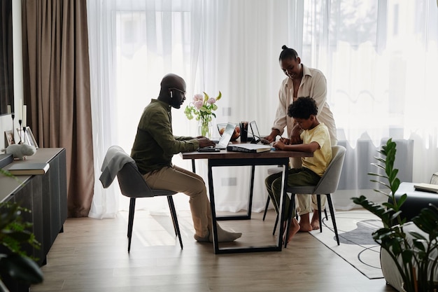 Mom helping her son to do homework