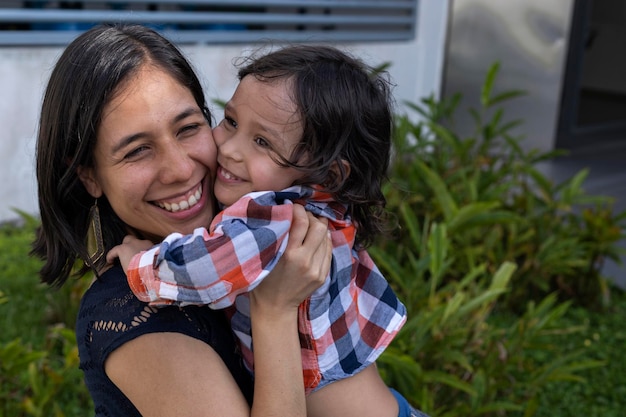 Mom and her Latin American son show their love with hugs and smiles Mother's day concept and family