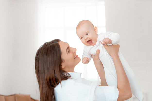 Mom holds the baby in her arms at home