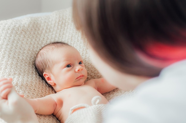 Mom holds the baby in her arms lifestyle Mother's love for her son A newborn baby