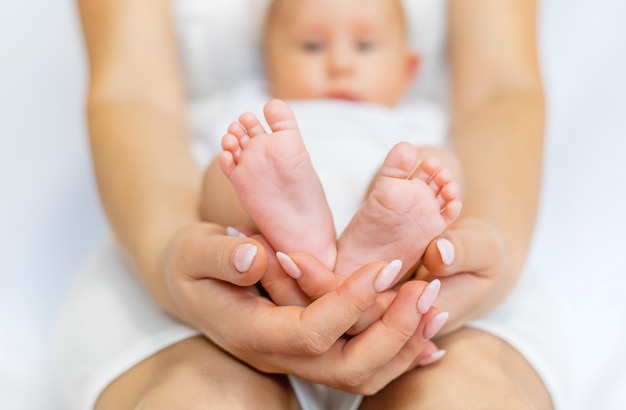 Mom holds the baby's legs