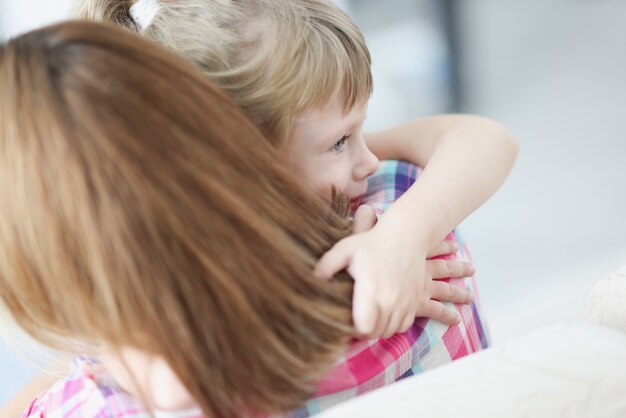 Mom holds little girl in her arms