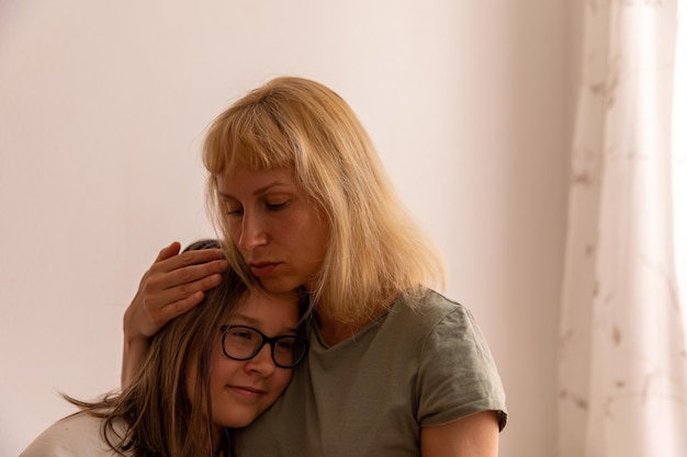 Mom hugs her daughter in the room