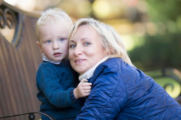 Mom hugs son on a walk in the parkLate motherhood