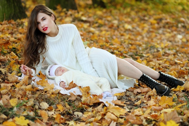 Mom and little daughter in autumn forest