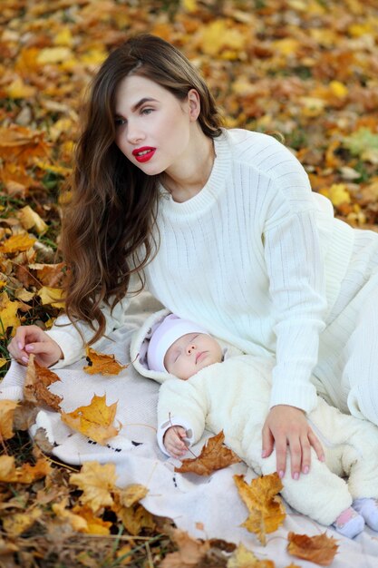 Mom and little daughter in autumn forest