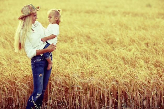 mom and little daughter in the summer on the nature of happiness