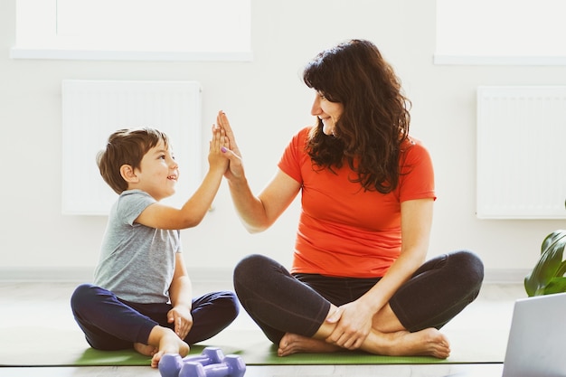 Mom and little son doing workout at home