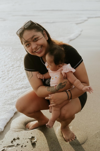 Mom and newborn daughter on the beach