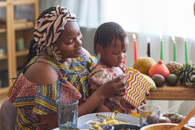 Mom opening gift with her child